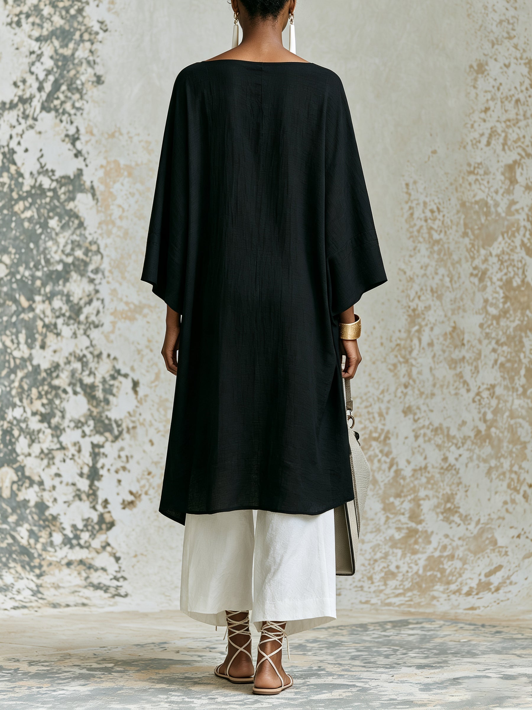 Elegant black asymmetrical top and white wide-leg pants set