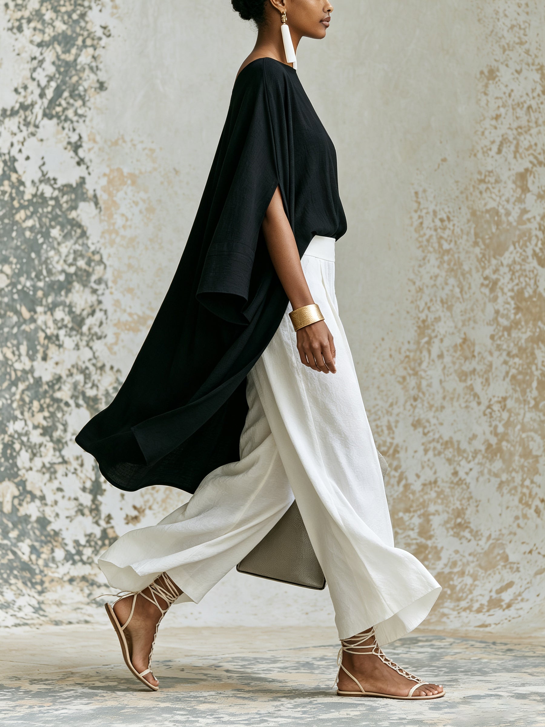 Elegant black asymmetrical top and white wide-leg pants set